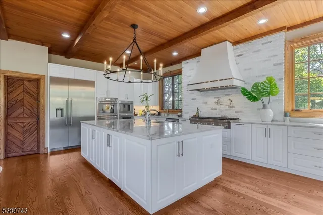 a kitchen with stainless steel appliances granite countertop a sink and cabinets