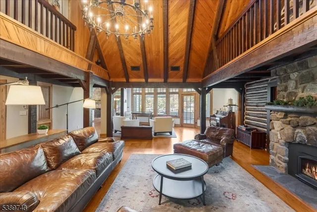 a living room with furniture a fireplace and a large window