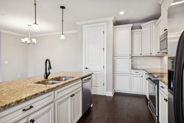 a kitchen with stainless steel appliances granite countertop a sink stove and refrigerator