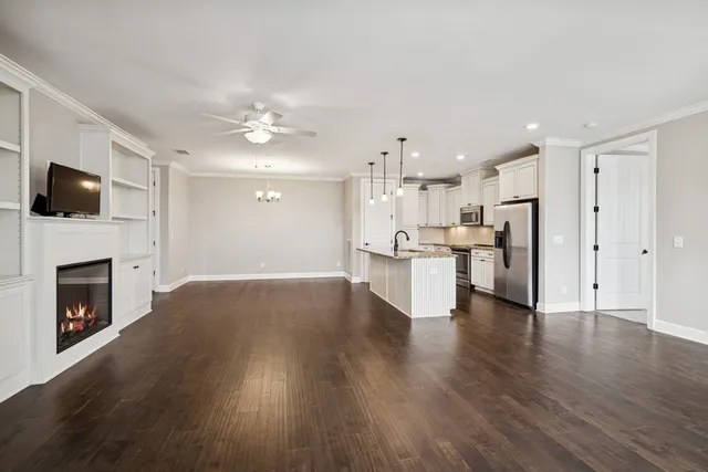 a view of kitchen with livingroom and fireplace wooden floor