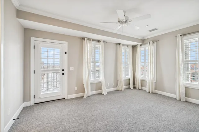 an empty room with windows and closet area