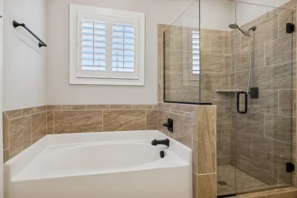 a bathroom with a bathtub and shower