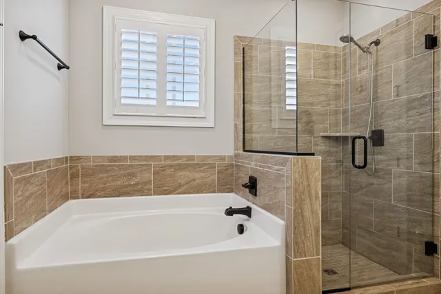 a bathroom with a bathtub and shower