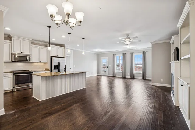 a view of kitchen with sink microwave and stove top oven