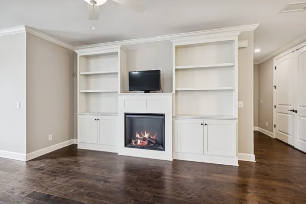 a living room with a fireplace and a flat screen tv