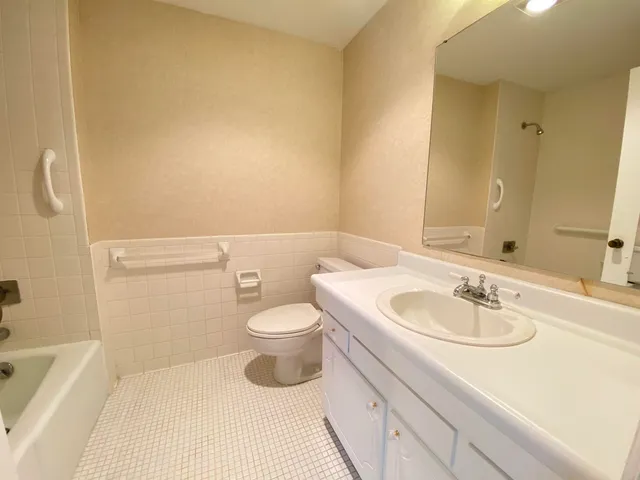 a bathroom with a sink a toilet and bathtub