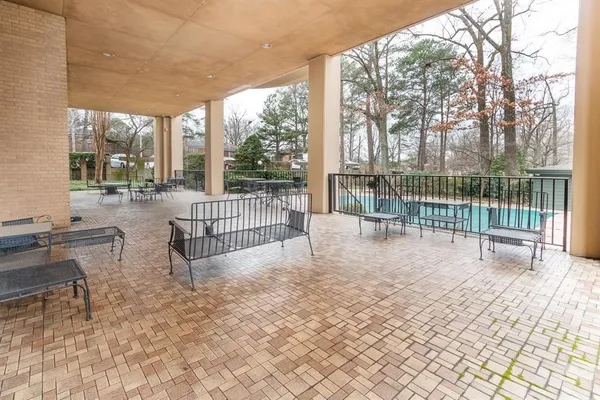 a view of a house with backyard and sitting area