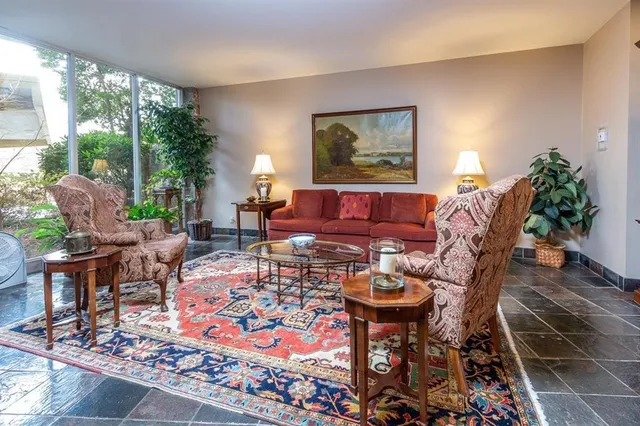 a living room with furniture and a potted plant