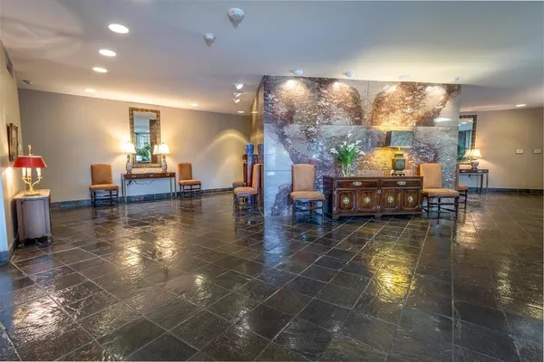 a dining room with furniture and a floor to ceiling window