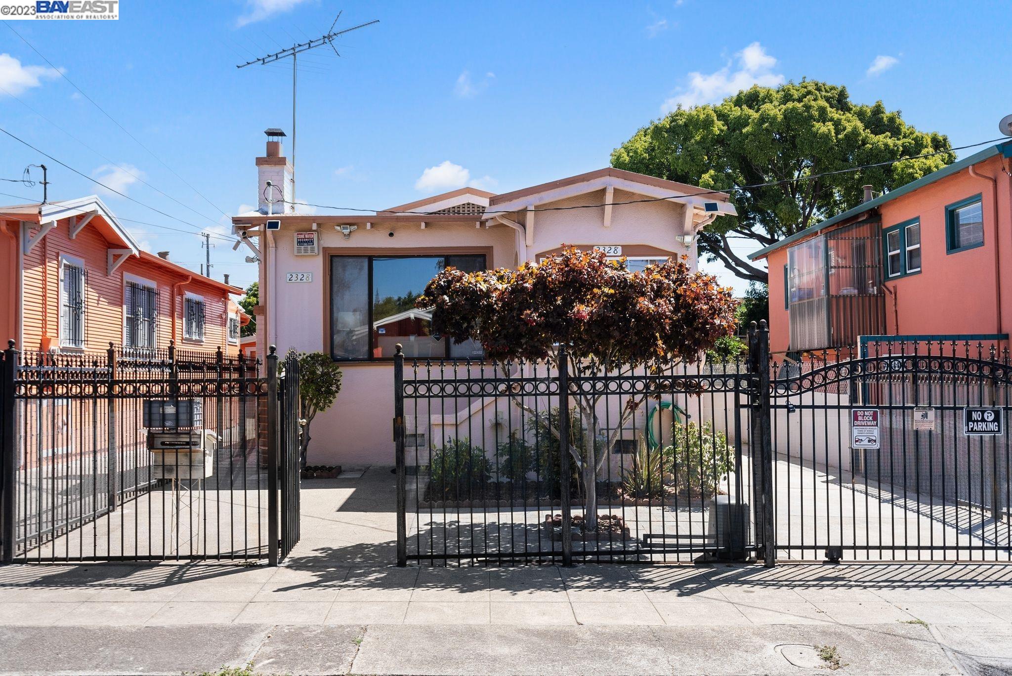 2328 Bartlett Street Oakland, CA 94601 - Photo 1 of 1 a front view of a house with a iron gate