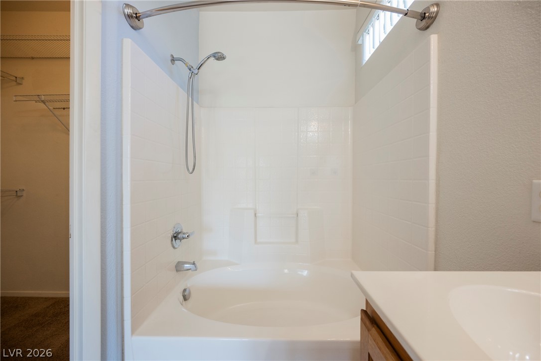 6320 Snap Ridge Street, Unit 201 North Las Vegas, NV 89081 - Photo 28 of 56 A well-lit bathroom features a shower-tub combination and convenient storage just beyond the door.