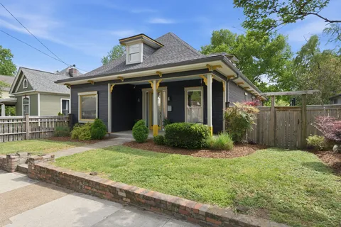 a view of a house with a yard and plants