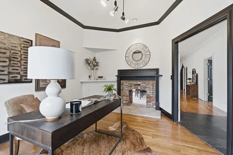 a view of empty room with wooden floor