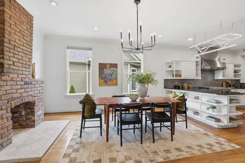 a living room with furniture a dining table and a wooden floor