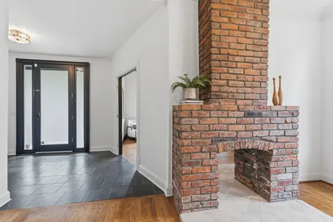 a living room with furniture a dining table and a window