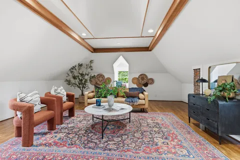 a view of a patio with couches table and chairs and potted plants