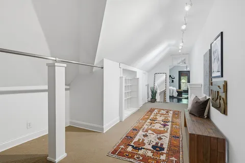 an aerial view of residential houses with outdoor space and trees