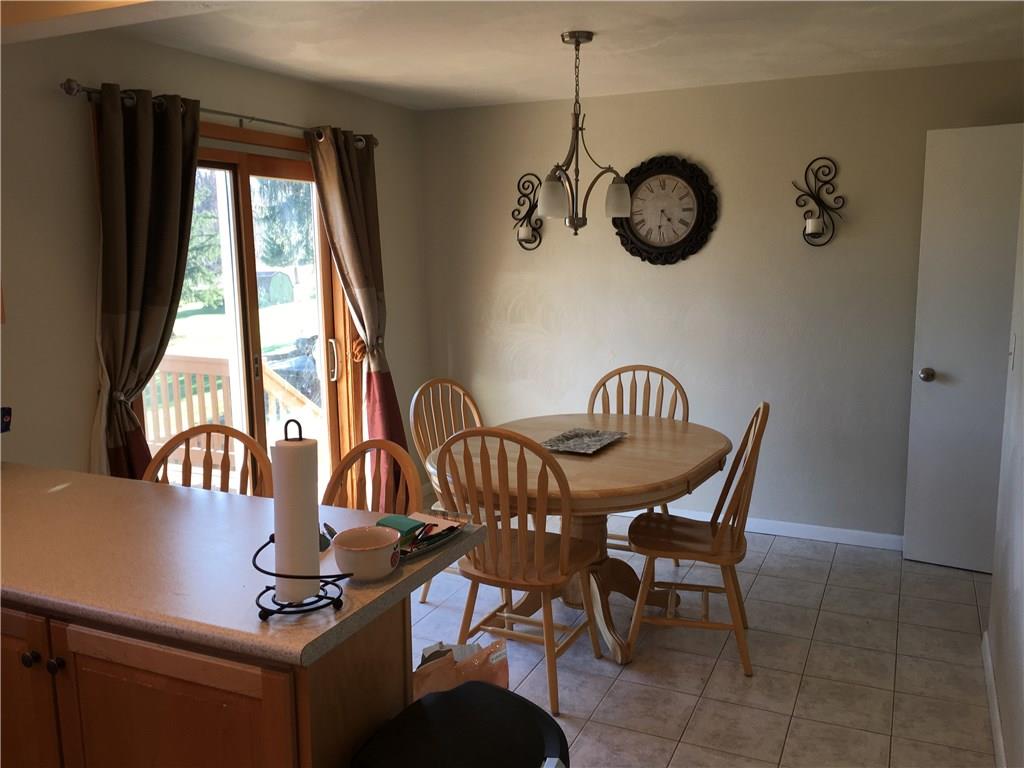 164 Jones Road Cabot, PA 16023 - Photo 9 of 23 Dining area with ceramic flooring and sliding door to a beautiful deck overlooking yard and fields