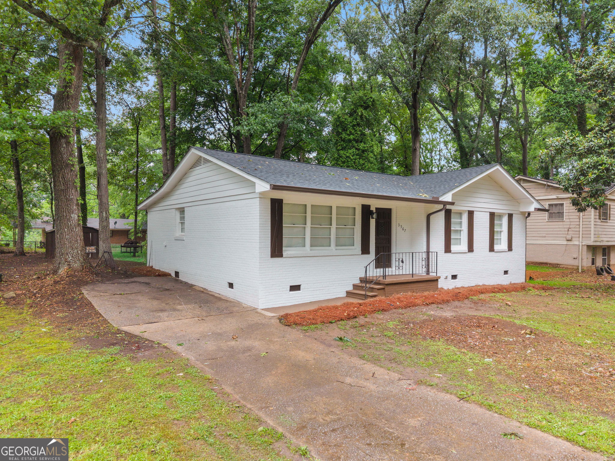 3567 Forrest Park Road Southeast Atlanta, GA 30354 - Photo 4 of 29 a front view of a house with a yard and garage
