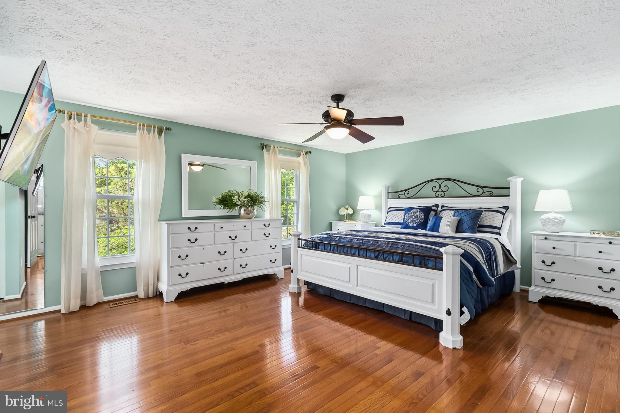 1004 Windmill Lane Silver Spring, MD 20905 - Photo 24 of 60 a bedroom with a bed and a chandelier