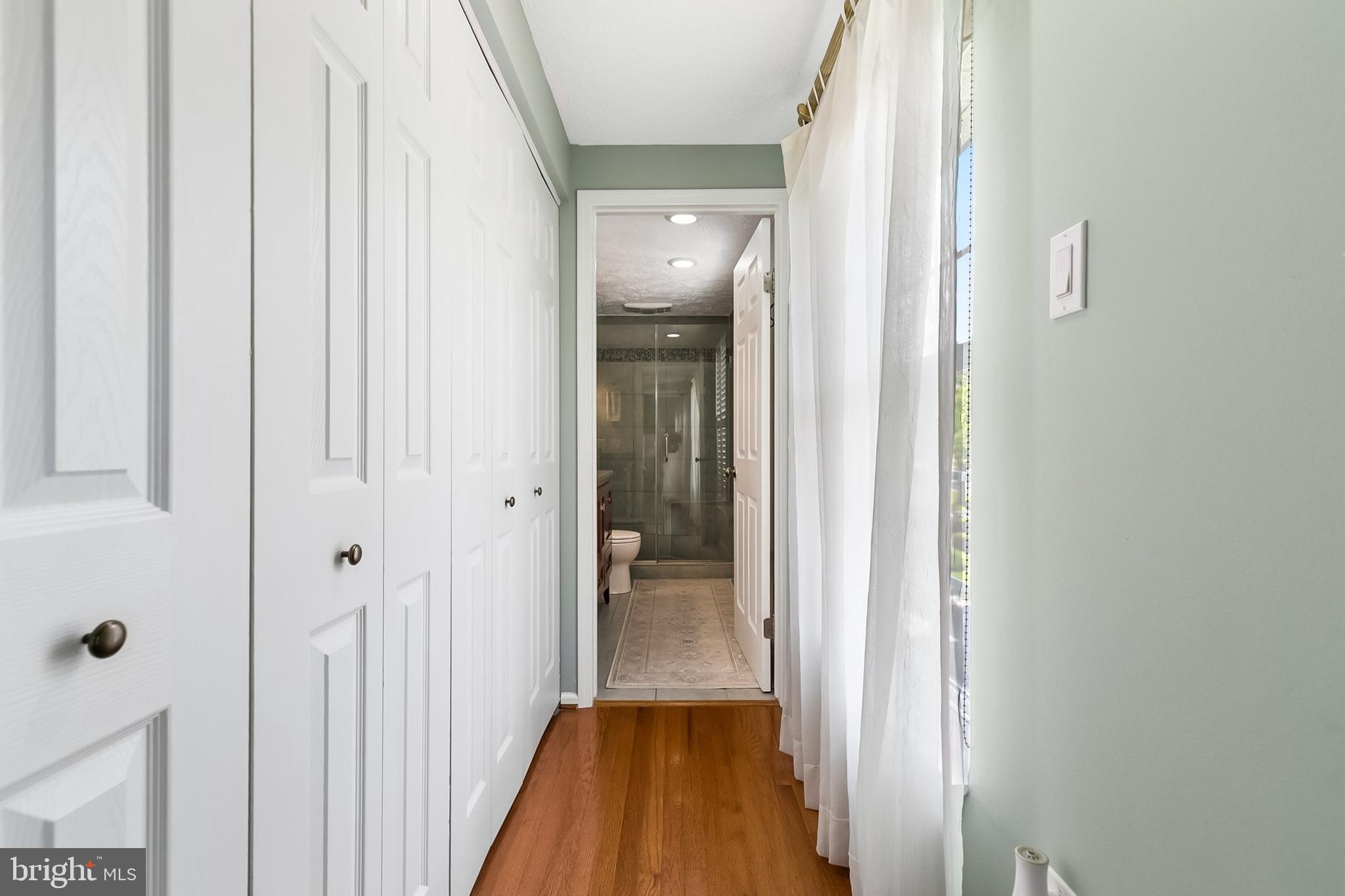 1004 Windmill Lane Silver Spring, MD 20905 - Photo 26 of 60 a view of a hallway with wooden floor and staircase