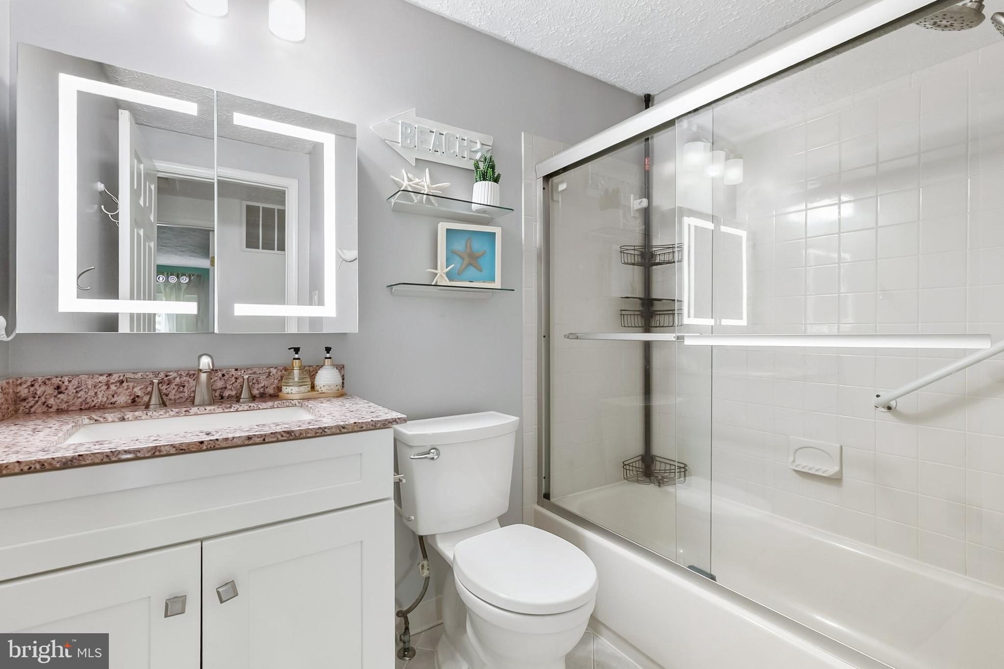 1004 Windmill Lane Silver Spring, MD 20905 - Photo 30 of 60 a bathroom with a sink toilet vanity and shower