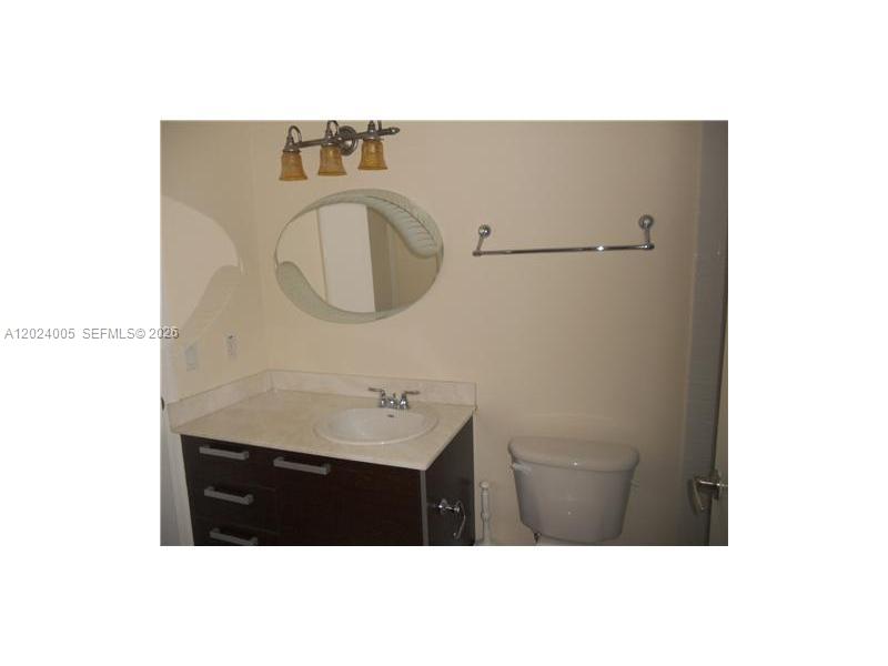 2525 Southwest 3rd Avenue, Unit 1006 Miami, FL 33129 - Photo 5 of 13 a bathroom with a sink and a mirror
