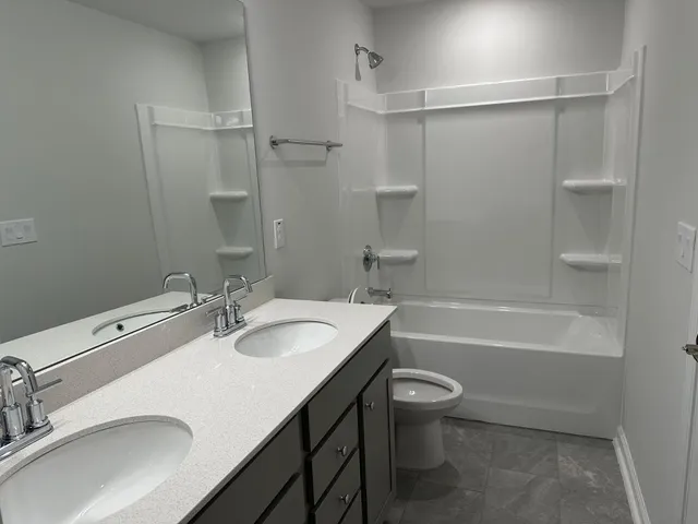 a bathroom with a sink a toilet and a bathtub