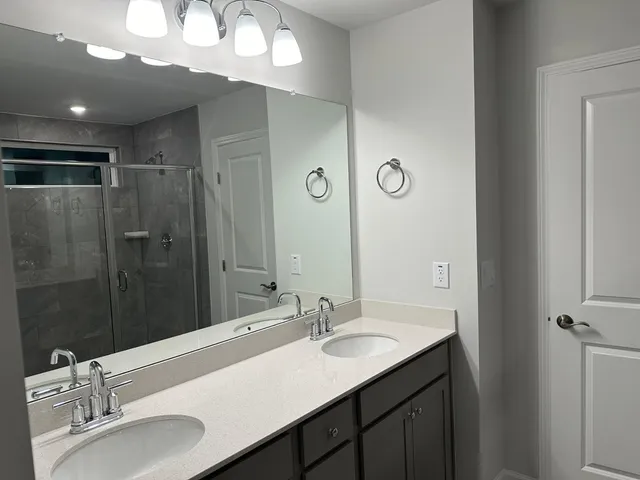 a bathroom with a sink vanity granite and a mirror