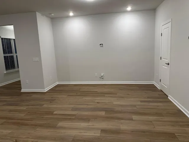 a view of room with wooden floor