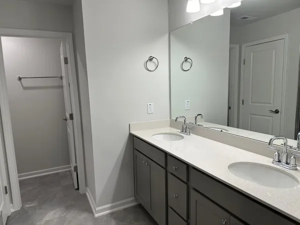 a bathroom with a double vanity sink and a mirror