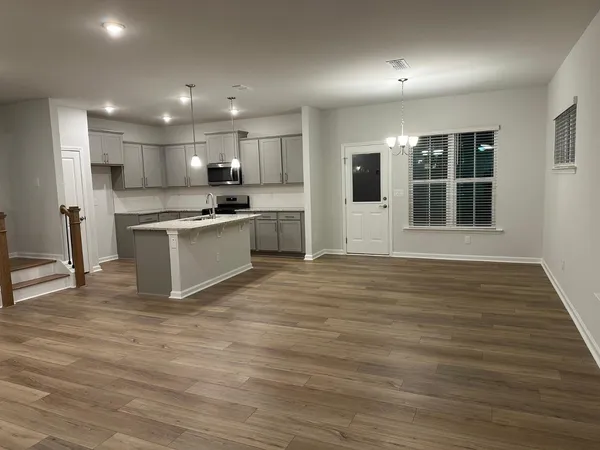 a large kitchen with stainless steel appliances granite countertop a stove and a sink