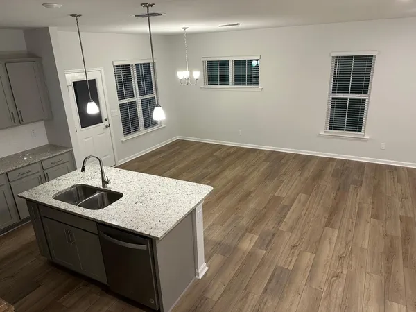 a kitchen with sink and mirror