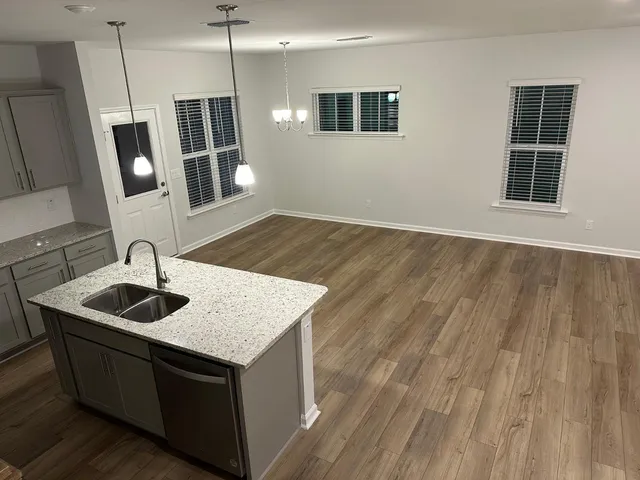 a kitchen with sink and mirror