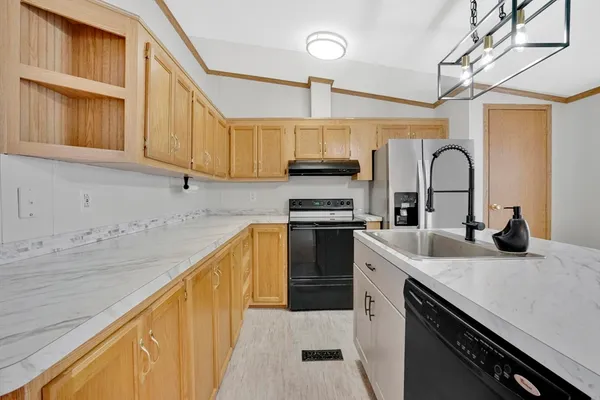 a kitchen with stainless steel appliances granite countertop a sink and cabinets