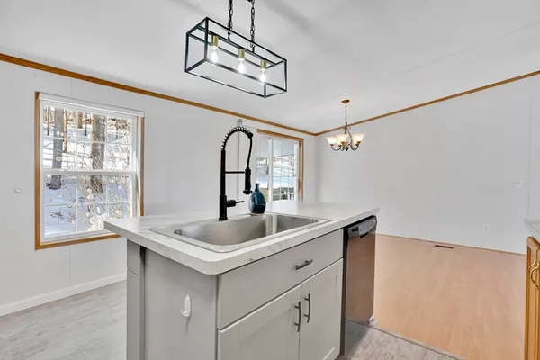 a bathroom with a sink and mirror with window