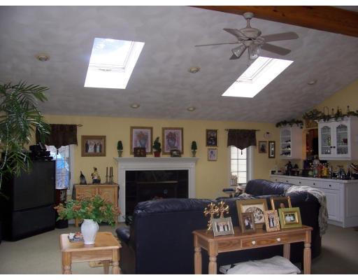 7 Argonne Road Billerica, MA 01821 - Photo 2 of 16 a living room with furniture a flat screen tv and a fireplace