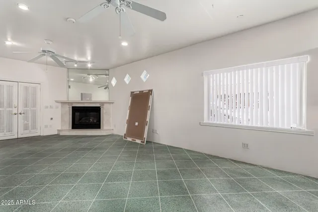 a view of an empty room with a fireplace and a window