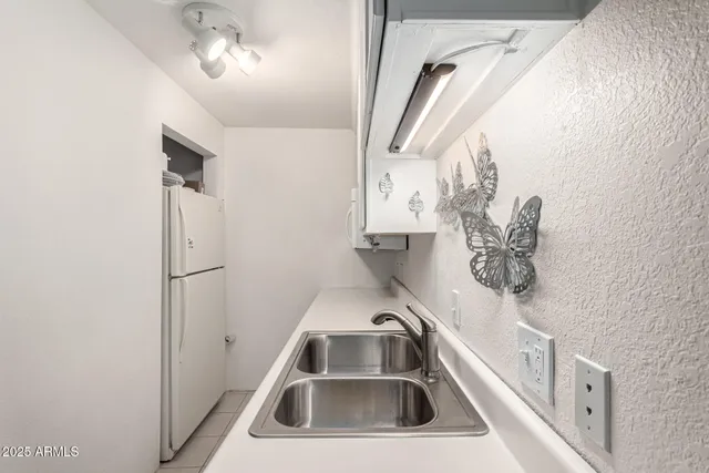 an empty room with chandelier fan