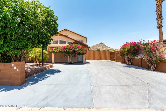 a front view of a house with a yard and a garage