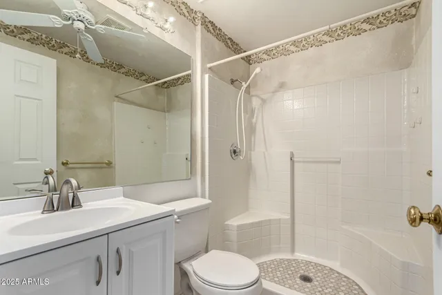 a view of an empty room with a chandelier fan