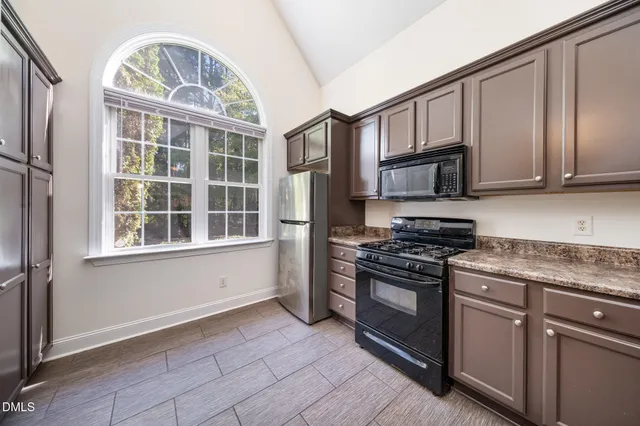 a kitchen with granite countertop stainless steel appliances and wooden cabinets