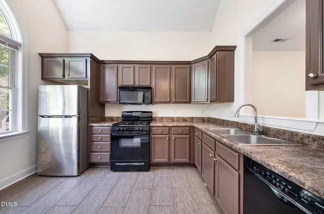 a kitchen with stainless steel appliances granite countertop a stove and a microwave