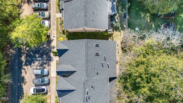an aerial view of residential houses with outdoor space and trees