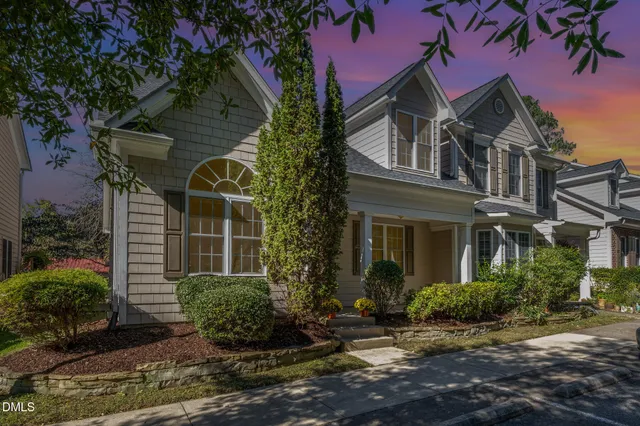 a aerial view of a house with a yard and large tree
