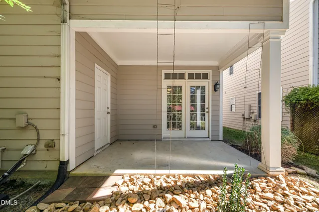 a view of a brick house with many windows next to a road