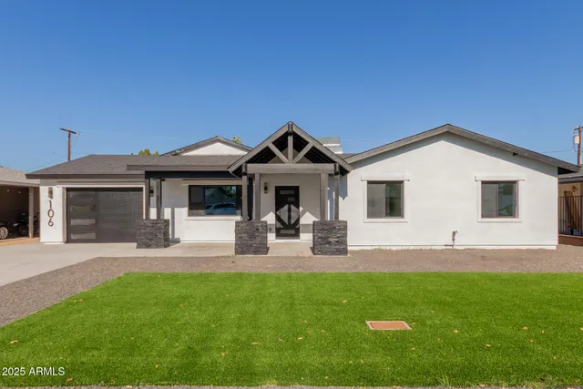 a front view of a house with garden and porch