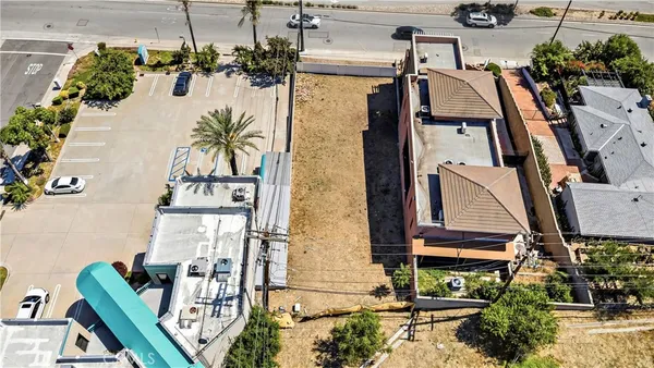 an aerial view of a residential apartment building with a yard