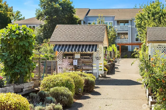 a front view of a house with a yard and seating space