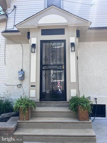a front view of a house with potted plants